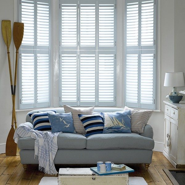 hinged shutters in a bay window